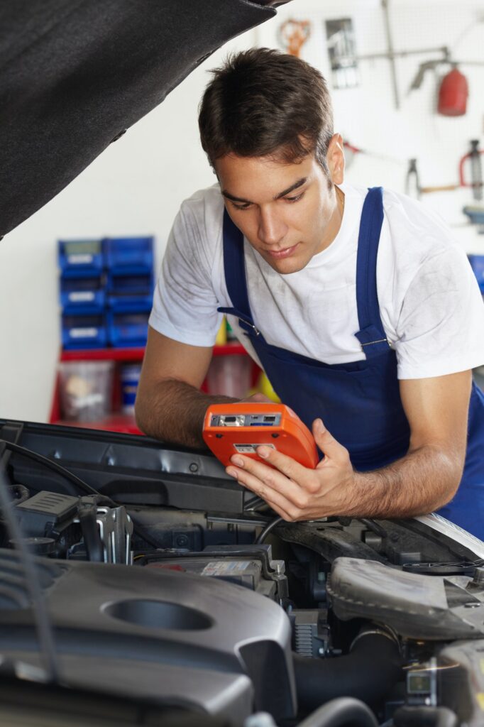 young-man-working-as-mechanic-repairing-car-engine